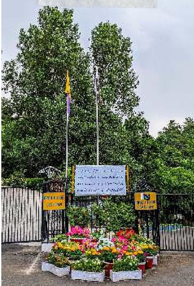 The college main gate, flagpoles and the circular flower bed. — Lawrence College Ghora Gali