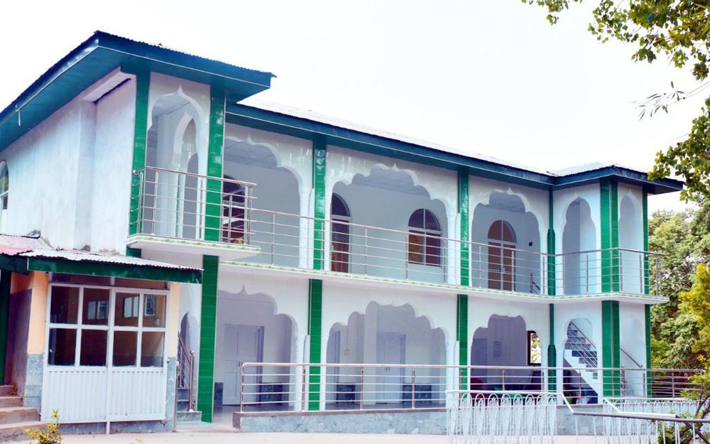 The Preparatory School mosque, a two-storey building in green and white