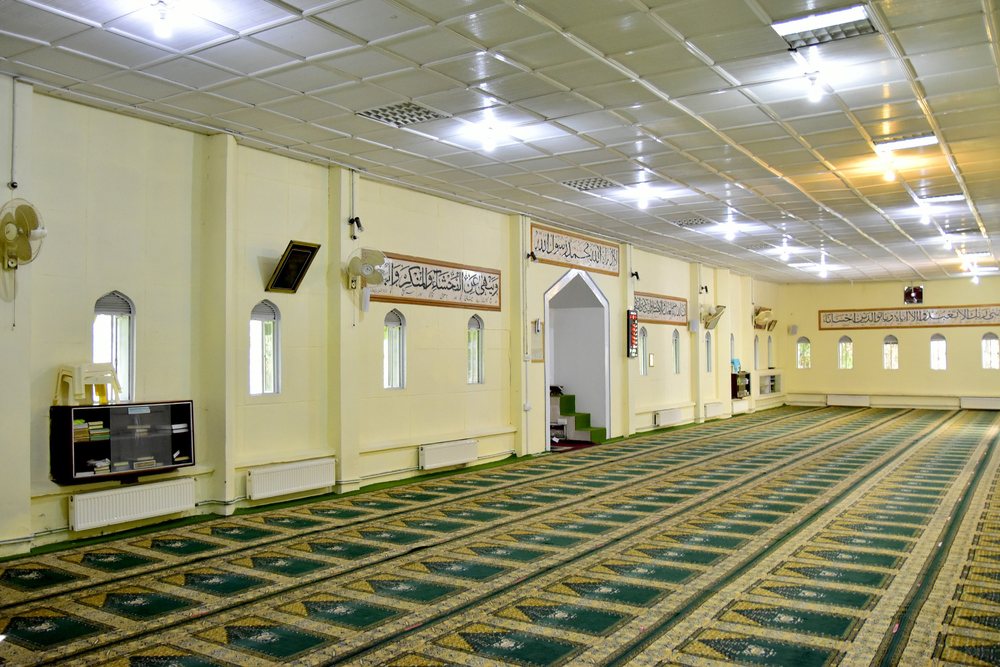 Inside the Senior School mosque, its prayer hall laid with green carpet