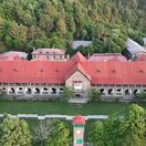 The College main building among the pines